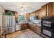 Kitchen with stainless steel appliances, tiled backsplash, and a window overlooking the yard at 11733 East 21St St, Indianapolis, IN 46229