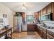 Kitchen with stainless steel appliances, window over sink, and wood-look floors at 11733 East 21St St, Indianapolis, IN 46229