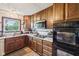 Kitchen with updated countertops, dark cabinets, and a modern microwave at 11733 East 21St St, Indianapolis, IN 46229