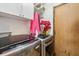 Laundry room with front load washer and dryer and upper cabinets at 11733 East 21St St, Indianapolis, IN 46229