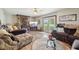 Inviting living room with stone fireplace, wood floors, and access to the outdoors at 11733 East 21St St, Indianapolis, IN 46229