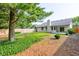 View of backyard featuring a ground cover, trees and white painted home exterior at 12258 Charing Cross Rd, Carmel, IN 46033