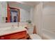 Bathroom features a sink vanity, toilet, and shower-tub combination with bright tile and updated fixtures at 12258 Charing Cross Rd, Carmel, IN 46033