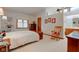 Bright bedroom showcases a vaulted ceiling, complemented by a plush bed and a charming rocking chair at 12258 Charing Cross Rd, Carmel, IN 46033
