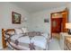 Bedroom features a wood-frame bed and a traditional quilt, complemented by a cozy atmosphere at 12258 Charing Cross Rd, Carmel, IN 46033