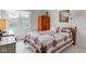 Bedroom with a quilt-covered bed, wood armoire, and a window providing natural light and an outdoor view at 12258 Charing Cross Rd, Carmel, IN 46033