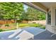 View from under a covered patio of the back yard featuring green ground cover and a wood fence at 12258 Charing Cross Rd, Carmel, IN 46033