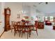 Inviting dining area with a chandelier, seamlessly connected to the living room and kitchen at 12258 Charing Cross Rd, Carmel, IN 46033