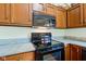 Close-up of kitchen with black oven, microwave, and granite countertop space at 12258 Charing Cross Rd, Carmel, IN 46033