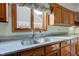 Kitchen counter features a double basin sink, granite counter and wood cabinets with ample counter space at 12258 Charing Cross Rd, Carmel, IN 46033