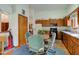 Kitchen with wood cabinets, granite counters, blue accents, and a connection to the dining area at 12258 Charing Cross Rd, Carmel, IN 46033