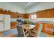 Kitchen with wood cabinets, granite counters, and a dining nook with coordinated chairs at 12258 Charing Cross Rd, Carmel, IN 46033