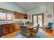 Eat-in kitchen with wood cabinets, granite countertops, and a view to the backyard at 12258 Charing Cross Rd, Carmel, IN 46033