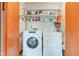 Laundry room features a modern washer and dryer set, with shelving providing storage solutions at 12258 Charing Cross Rd, Carmel, IN 46033