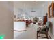 Spacious living room with fireplace and elegant chandelier, flowing into the dining area at 12258 Charing Cross Rd, Carmel, IN 46033