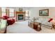 Cozy living room featuring a brick fireplace, large windows, and comfortable furniture at 12258 Charing Cross Rd, Carmel, IN 46033