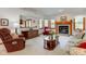 Inviting living room with brick fireplace, wood accents, and comfortable seating arrangement at 12258 Charing Cross Rd, Carmel, IN 46033
