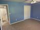 Blue bedroom with plush carpet and access to an ensuite bathroom at 12301 Winding Creek Cir, Indianapolis, IN 46236