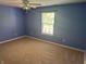 Blue bedroom with plush carpet, ceiling fan, and a window that lets in natural light at 12301 Winding Creek Cir, Indianapolis, IN 46236