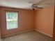 Comfortable peach bedroom with plush carpet and a window view at 12301 Winding Creek Cir, Indianapolis, IN 46236