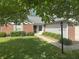 Charming single story home with lush lawn, manicured hedges and brick accents on a tree lined street at 12301 Winding Creek Cir, Indianapolis, IN 46236