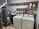 Laundry room has washer, dryer, shelving, and water heater at 12301 Winding Creek Cir, Indianapolis, IN 46236