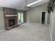 Spacious living room featuring a skylight, ceiling fan, fireplace, and access to the backyard at 12301 Winding Creek Cir, Indianapolis, IN 46236