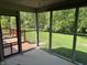 Relaxing screened porch with views of the lush backyard and a wooden deck at 12301 Winding Creek Cir, Indianapolis, IN 46236