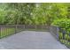 Large back deck overlooking a well-maintained yard and lush trees, providing privacy and a great space for outdoor gatherings at 12563 Sandstone Run, Carmel, IN 46033