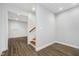 Hallway with vinyl plank flooring leading to stairs and additional rooms at 12563 Sandstone Run, Carmel, IN 46033