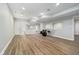 Finished basement space with vinyl plank flooring, mirrors, and drum set at 12563 Sandstone Run, Carmel, IN 46033