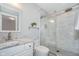 A modern bathroom with a glass enclosed shower, a sleek vanity, and elegant marble tile at 12563 Sandstone Run, Carmel, IN 46033