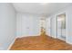 A light-filled bedroom with hardwood flooring and adjacent ensuite bathroom and closet space at 12563 Sandstone Run, Carmel, IN 46033