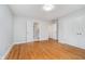 A spacious bedroom with hardwood floors featuring an ensuite bathroom and double-door closet at 12563 Sandstone Run, Carmel, IN 46033