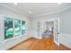 Dining room featuring hardwood floors, large windows, and access to another room through double doors at 12563 Sandstone Run, Carmel, IN 46033