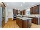 Modern kitchen features custom cabinets, granite counters, an island and stainless steel appliances at 12563 Sandstone Run, Carmel, IN 46033