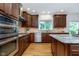 Well-lit kitchen with stainless appliances, granite countertops, and beautiful wood cabinetry at 12563 Sandstone Run, Carmel, IN 46033