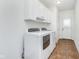 Clean laundry room with cabinets above the washer and dryer, as well as tile floors at 12563 Sandstone Run, Carmel, IN 46033