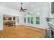 Open concept living space featuring a fireplace, hardwood floors and many large windows at 12563 Sandstone Run, Carmel, IN 46033