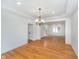Large living room boasting hardwood floors, recessed lighting, and traditional chandelier at 12563 Sandstone Run, Carmel, IN 46033