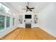 Bright living room featuring a fireplace, built-in shelving, ceiling fan and hardwood floors at 12563 Sandstone Run, Carmel, IN 46033