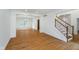 Bright living room featuring hardwood floors, a staircase, and an open floor plan at 12563 Sandstone Run, Carmel, IN 46033