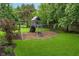 Backyard playground area on lush green grass, perfect for with swings and a playset at 12563 Sandstone Run, Carmel, IN 46033