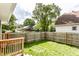 View of a grassy backyard featuring a wooden fence and mature trees, offering a serene outdoor space at 1342 N Oakland Ave, Indianapolis, IN 46201
