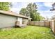 Backyard featuring well-maintained lawn, small patio and wood fence at 1342 N Oakland Ave, Indianapolis, IN 46201