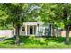 Charming home exterior framed by lush trees, showcasing a welcoming front porch and inviting curb appeal at 1342 N Oakland Ave, Indianapolis, IN 46201