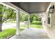 Covered front porch with stately columns overlooking a verdant front yard at 1342 N Oakland Ave, Indianapolis, IN 46201