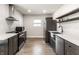 Modern kitchen with stainless steel appliances, dark cabinetry, and bright countertop, creating a sleek and functional space at 1342 N Oakland Ave, Indianapolis, IN 46201