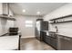 Well-lit kitchen featuring stainless steel appliances, dark cabinetry, and a modern design for a stylish cooking experience at 1342 N Oakland Ave, Indianapolis, IN 46201