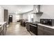 Bright open-plan living room and kitchen with modern stainless-steel appliances and an adjacent dining area at 1342 N Oakland Ave, Indianapolis, IN 46201